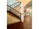 Elegant foyer with a hardwood floor, staircase with wrought iron railing, and arched doorway leading to the kitchen at 2961 River Ridge Drive Sw, Atlanta, GA 30354