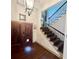 Grand foyer with a staircase with wrought iron spindles, hardwood floors and a wooden front door at 2961 River Ridge Drive Sw, Atlanta, GA 30354