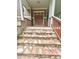 Close-up of the house's stone steps leading to the covered porch with a wooden railing and double door entrance at 2961 River Ridge Drive Sw, Atlanta, GA 30354