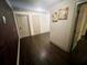 Hallway with pristine hardwood flooring, neutral paint, and multiple entry points at 2961 River Ridge Drive Sw, Atlanta, GA 30354
