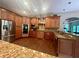 Gourmet kitchen with custom wood cabinetry, stainless steel appliances, granite countertops, and hardwood flooring at 2961 River Ridge Drive Sw, Atlanta, GA 30354
