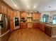 Gourmet kitchen with custom wood cabinetry, stainless steel appliances, granite countertops, and hardwood flooring at 2961 River Ridge Drive Sw, Atlanta, GA 30354