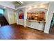 Open-concept kitchen view highlighting hardwood floors, kitchen breakfast bar, and access to the staircase at 2961 River Ridge Drive Sw, Atlanta, GA 30354