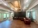 Large living room with hardwood floors, coffered ceilings, and a seating area near a window with a Christmas tree at 2961 River Ridge Drive Sw, Atlanta, GA 30354