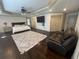 Spacious main bedroom with a sitting area, mounted TV, and trey ceilings at 2961 River Ridge Drive Sw, Atlanta, GA 30354