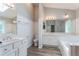 Bathroom featuring a white vanity with double sinks, a toilet, and a tub with a glass door at 1797 Emerson Lake Cir, Snellville, GA 30078