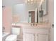 Bathroom featuring a white vanity, toilet, and tub with pink tiles at 1797 Emerson Lake Cir, Snellville, GA 30078