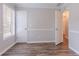An empty room featuring gray walls with white trim, wood-look laminate flooring, and two white doors at 1797 Emerson Lake Cir, Snellville, GA 30078