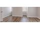 An empty room featuring gray walls, white trim, and wood-look laminate flooring at 1797 Emerson Lake Cir, Snellville, GA 30078
