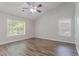 Bedroom featuring gray walls, white trim, wood-look laminate flooring, and a ceiling fan at 1797 Emerson Lake Cir, Snellville, GA 30078