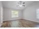 Bedroom featuring gray walls, white trim, wood-look laminate flooring, and a ceiling fan at 1797 Emerson Lake Cir, Snellville, GA 30078