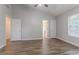 Bedroom featuring gray walls, white trim, wood-look laminate flooring, and two doors at 1797 Emerson Lake Cir, Snellville, GA 30078