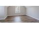 Cozy bedroom with natural light from the window and wood-style laminate flooring at 1797 Emerson Lake Cir, Snellville, GA 30078