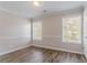 An empty room featuring gray walls with a white accent stripe, white trim, and wood-look laminate flooring at 1797 Emerson Lake Cir, Snellville, GA 30078
