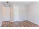 An empty room featuring gray walls, white trim, and wood-look laminate flooring with two doors at 1797 Emerson Lake Cir, Snellville, GA 30078