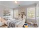 Bright bedroom with playful decor, large windows, and modern furnishings at 1797 Emerson Lake Cir, Snellville, GA 30078