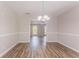 Open dining room area featuring wood floors, modern lighting, and open access to living areas at 1797 Emerson Lake Cir, Snellville, GA 30078