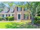 Charming brick home featuring black shutters and a well-manicured front yard at 1797 Emerson Lake Cir, Snellville, GA 30078