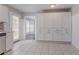 Spacious kitchen with generous storage, white cabinets, tile flooring and access to outdoor at 1797 Emerson Lake Cir, Snellville, GA 30078