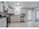 Bright kitchen boasts stainless steel appliances, granite countertops, and tile flooring at 1797 Emerson Lake Cir, Snellville, GA 30078