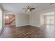 Inviting living room with hardwood floors, ceiling fan, and convenient access to stairs at 1797 Emerson Lake Cir, Snellville, GA 30078