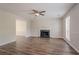 Cozy living room featuring fireplace, ceiling fan, and seamless flow to other areas at 1797 Emerson Lake Cir, Snellville, GA 30078