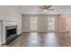 Open living room showcases a classic fireplace, ceiling fan, and natural light from windows at 1797 Emerson Lake Cir, Snellville, GA 30078