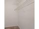 This walk-in closet has carpeted floor and wire shelving for ample storage space at 1797 Emerson Lake Cir, Snellville, GA 30078
