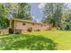 Spacious backyard with mature trees and a well-maintained lawn with a wooden deck at 2783 Bicentennial Dr, Stone Mountain, GA 30087