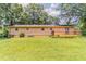Expansive backyard showcasing lush lawn space, mature trees, and a cozy wood deck at 2783 Bicentennial Dr, Stone Mountain, GA 30087