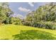 Large grassy backyard surrounded by mature trees offers ample space for outdoor activities at 2783 Bicentennial Dr, Stone Mountain, GA 30087