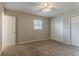 Comfortable bedroom with neutral walls, a ceiling fan, and double closets for storage at 2783 Bicentennial Dr, Stone Mountain, GA 30087