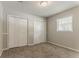 Bedroom with large closets and neutral carpeting and paint at 2783 Bicentennial Dr, Stone Mountain, GA 30087