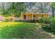 Charming single-story home with a welcoming front porch and a lush green lawn at 2783 Bicentennial Dr, Stone Mountain, GA 30087