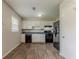 Efficient kitchen features white cabinets, dark appliances, and modern wood flooring at 2783 Bicentennial Dr, Stone Mountain, GA 30087