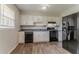 Functional kitchen featuring white cabinets and modern wood flooring at 2783 Bicentennial Dr, Stone Mountain, GA 30087