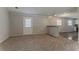 Cozy living room features new carpet and access to kitchen and backyard at 2783 Bicentennial Dr, Stone Mountain, GA 30087