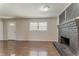 Comfortable living room featuring modern flooring and a striking brick fireplace at 2783 Bicentennial Dr, Stone Mountain, GA 30087