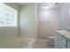 A simple white bathtub and separate shower stall near a window at 2957 Temple Johnson Rd, Snellville, GA 30039
