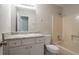 Full bathroom featuring tile countertops and a shower-tub combo at 2957 Temple Johnson Rd, Snellville, GA 30039