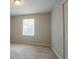 Spacious bedroom with neutral carpet, natural lighting, and a closet at 2957 Temple Johnson Rd, Snellville, GA 30039