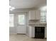 Eat-in kitchen featuring white cabinets, black appliances, granite countertops and a back door at 2957 Temple Johnson Rd, Snellville, GA 30039