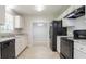 Charming kitchen features granite countertops, white cabinets, and modern black appliances at 2957 Temple Johnson Rd, Snellville, GA 30039