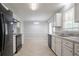 Bright kitchen features granite countertops, white cabinets, black appliances, and neutral tile floors at 2957 Temple Johnson Rd, Snellville, GA 30039