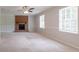 Large, airy living room featuring a classic brick fireplace and ample natural light at 2957 Temple Johnson Rd, Snellville, GA 30039