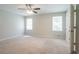 Large main bedroom with neutral walls and carpet features windows and an ensuite bathroom at 2957 Temple Johnson Rd, Snellville, GA 30039