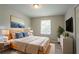Comfortable main bedroom with a large window and modern decor at 2957 Temple Johnson Rd, Snellville, GA 30039