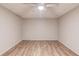 Unfinished basement area featuring vinyl wood flooring, neutral paint, and a ceiling fan at 5040 Fawn Valley Dr, Loganville, GA 30052