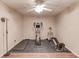 Home gym features workout machines, rubber floor tiles, and a ceiling fan at 5040 Fawn Valley Dr, Loganville, GA 30052