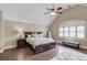 Primary bedroom featuring a trey ceiling, large windows, and a bench at 5040 Fawn Valley Dr, Loganville, GA 30052